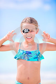 Beautiful little girl on beach having fun. Happy girl enjoy summer vacation background the blue sky and turquoise water