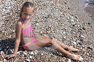 Beautiful little girl in a bikini posing