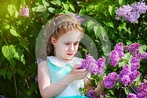 Beautiful little girl in a blue dress with a large white bow in