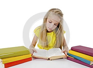 Beautiful little girl with the books. Adorable pretty girl reading book, studying
