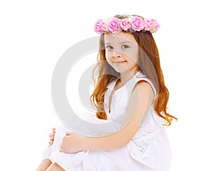 Beautiful little girl child with wreath of flowers on head