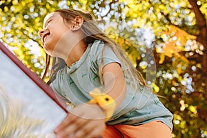 A beautiful little girl is climbing a slide