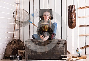 Beautiful little girl in cowboy hat with drum