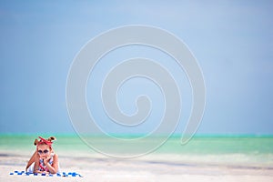 Beautiful little girl in dress at the beach. Funny girl enjoy summer vacation.