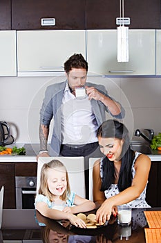 Beautiful little girl drinking milk and cookies