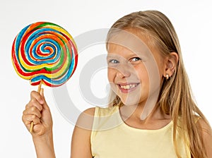 Beautiful little girl eating lollipop on white background