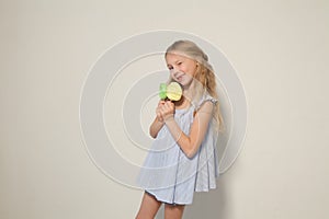 Beautiful little girl eating sweet candy lollipop cake