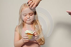 Beautiful little girl eating sweet candy lollipop cake