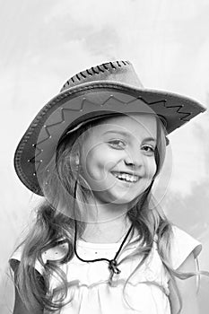 Beautiful little girl in fashion cowboy hat has happy face