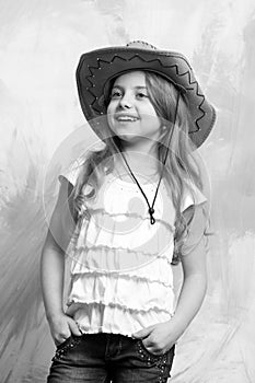 Beautiful little girl in fashion cowboy hat has happy face