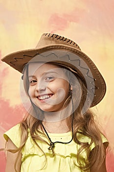 Beautiful little girl in fashion cowboy hat has happy face