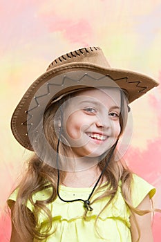 Beautiful little girl in fashion cowboy hat has happy face