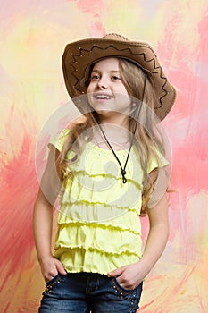 Beautiful little girl in fashion cowboy hat has happy face