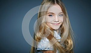 Beautiful little girl on grey background