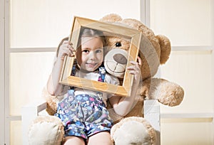 Beautiful little girl and her Teddy bear friend