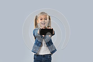 Beautiful Little Girl Hold Cell Smart Phone Empty Screen Happy Smiling Wear Jeans Coat Isolated