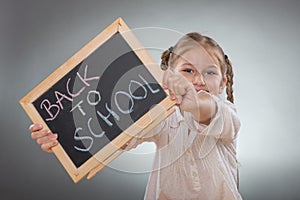 Beautiful little girl holding board on Back To School subtitles photo