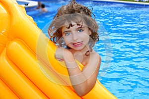 Beautiful little girl holding pool float smiling