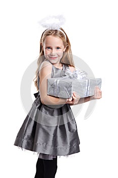 Beautiful little girl holding a wrapped gift