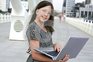 Beautiful little girl with laptop computer