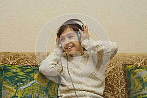 Beautiful little girl listening to music