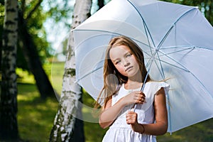 Beautiful little girl looks away dreaming