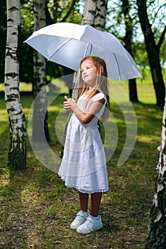 Beautiful little girl looks away dreaming