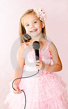 Beautiful little girl with microphone