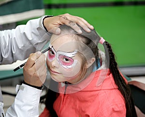 Beautiful little girl with a painted face