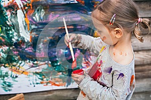 Beautiful little girl painting