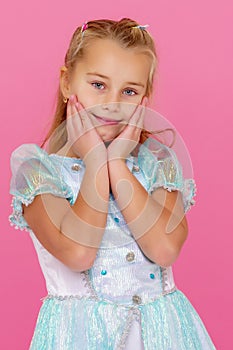 Beautiful little girl on a pink background.