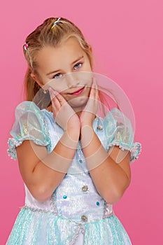 Beautiful little girl on a pink background. photo