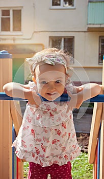 Beautiful little girl playing on tne playground