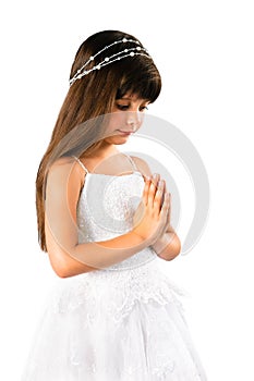 Beautiful little girl praying on white