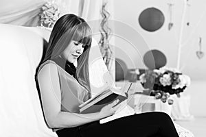 Beautiful little girl reading book