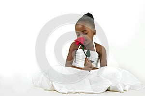Beautiful little girl with red rose