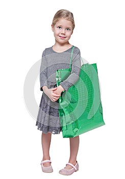 Beautiful little girl with shopping bag isolated