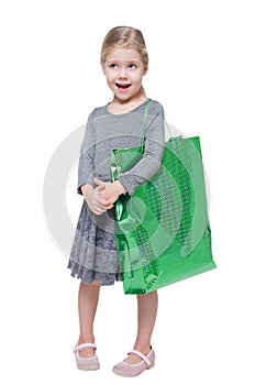 Beautiful little girl with shopping bag isolated