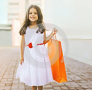 Beautiful little girl with shopping bag