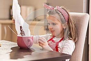 Pouring cereal into a bowl with milk