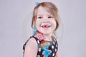 Beautiful little girl smiles a toothless smile