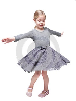 Beautiful little girl spinning around isolated