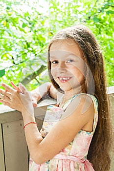 Beautiful little girl in summer background