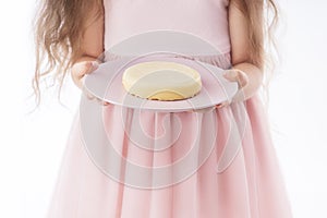 Beautiful little girl surprised from a tasty cheesecake. Kid ready to eat cake