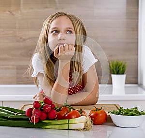 Beautiful little girl thinking about cooking.