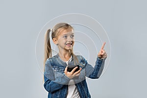 Beautiful Little Girl Using Cell Smart Phone Happy Smiling Point Finger To Copy Space Isolated