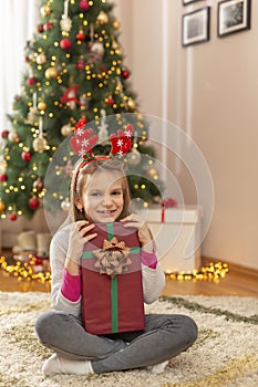 Little girl holding a Christmas gift