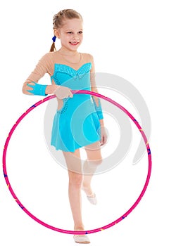 Beautiful little gymnast with the hoop