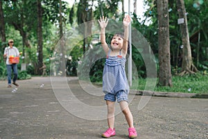 Beautiful little haired hair girl, has happy fun smiling face, pretty eyes, short hair, playing soap bubbles, dressed, Child