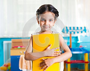 Beautiful little latin girl portrait in daycare